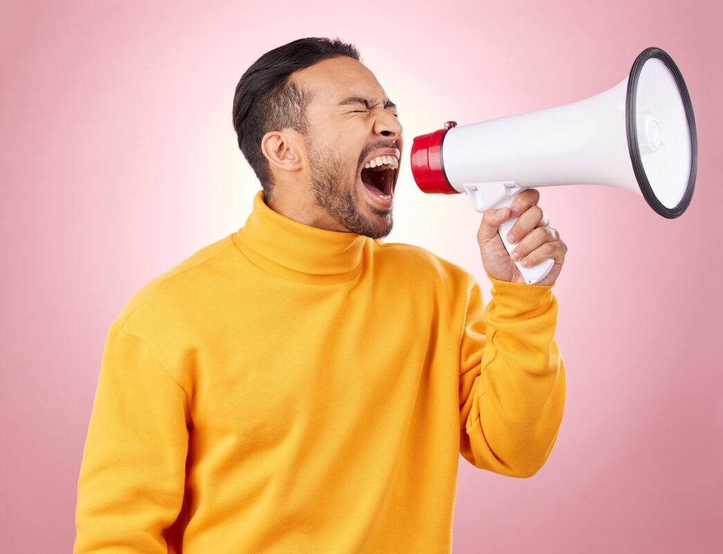 Asian,man,,megaphone,and,screaming,for,discount,,sale,or,alert