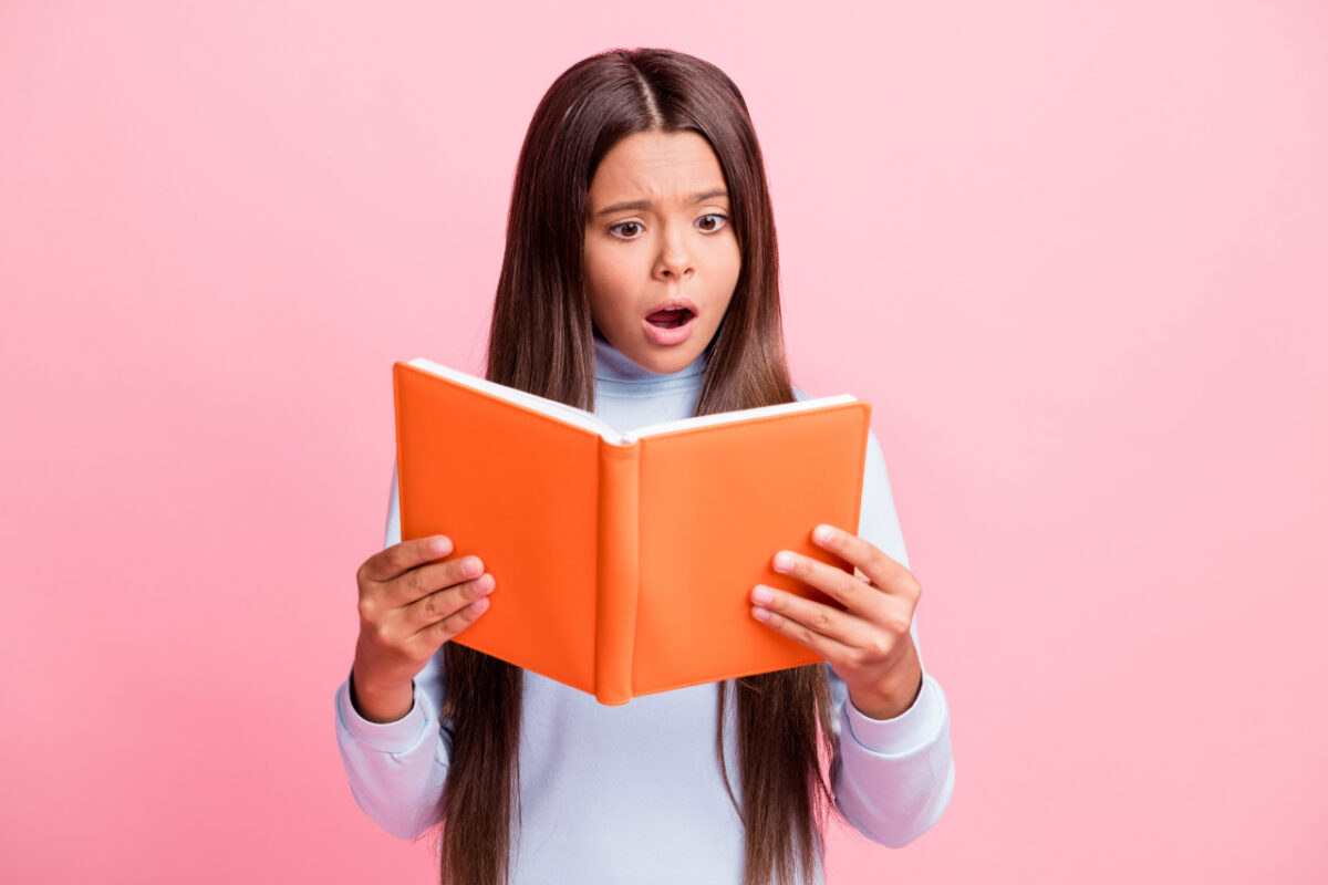 Portrait,of,pretty,outraged,focused,brown Haired,girl,reading,book,worrying