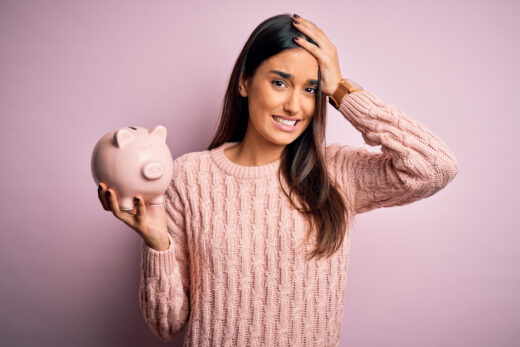 Young,beautiful,brunette,woman,holding,piggy,bank,saving,money,for