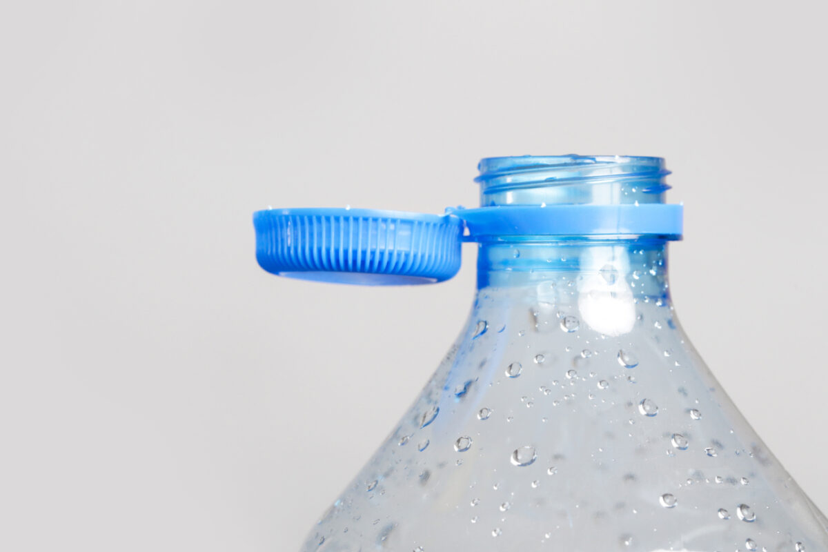 Close,up,of,new,cap,attached,to,plastic,bottle,,connected
