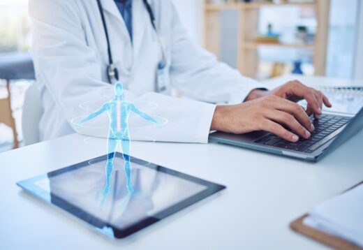 Doctor,typing,,laptop,and,tablet,hologram,,futuristic,body,graphic,or