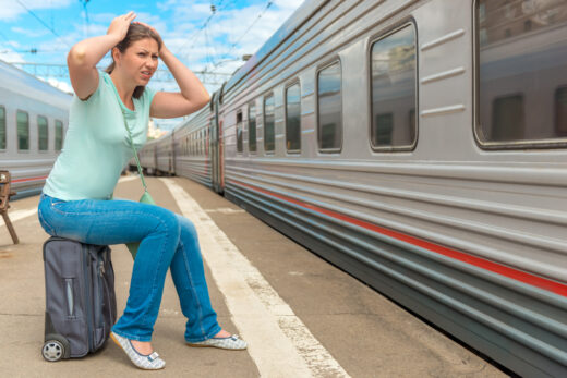 Frustrated,woman,looking,at,the,passing,train,on,which,she