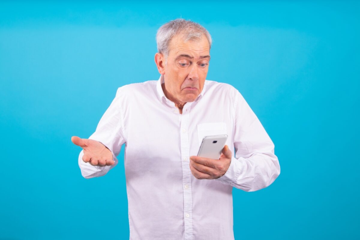 Isolated,adult,or,senior,man,with,mobile,phone,and,expression