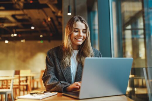 Stylish,woman,manager,freelancer,working,on,laptop,while,sitting,in