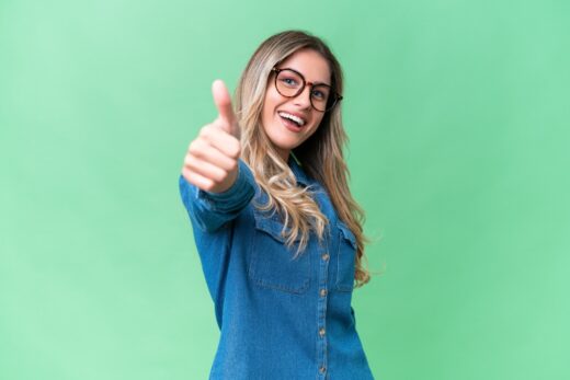 Young,uruguayan,woman,over,isolated,background,with,thumbs,up,because