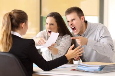 Angry,couple,claiming,and,shouting,to,an,office,worker