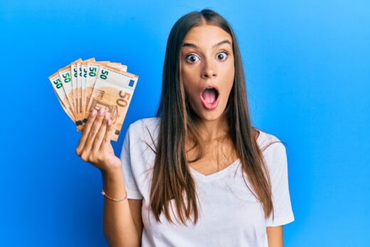 Young,hispanic,woman,holding,50,euro,banknotes,scared,and,amazed